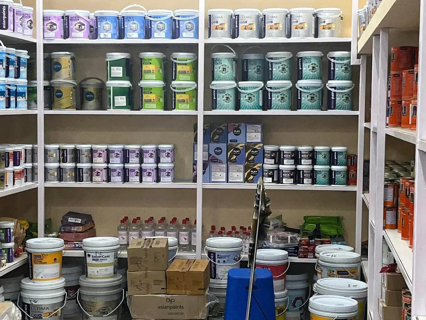 Shelves of Asian Paints shade tins in the store
